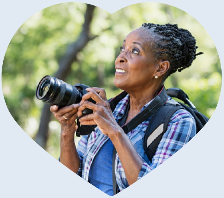 A woman taking a picture in nature